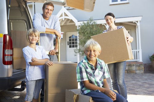 Packed moving boxes and protected furniture prepared for transport