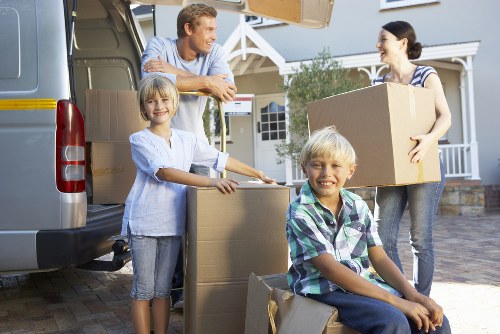 Supervised movers loading items into a removal vehicle securely