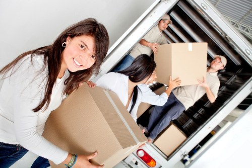 Professional movers loading furniture for transport in Southwark