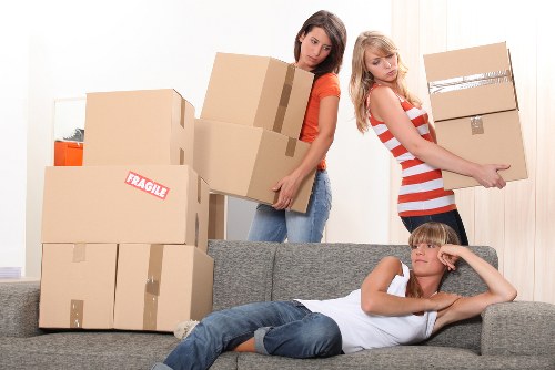Removal team handling furniture in a Southwark property